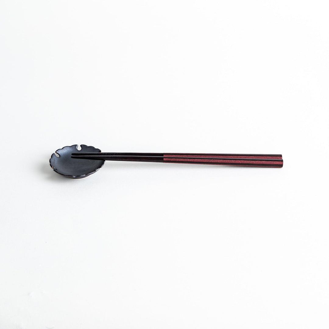 Octagonal wooden chopsticks with a brown tone, finished with a textured grain. Available in red or black.