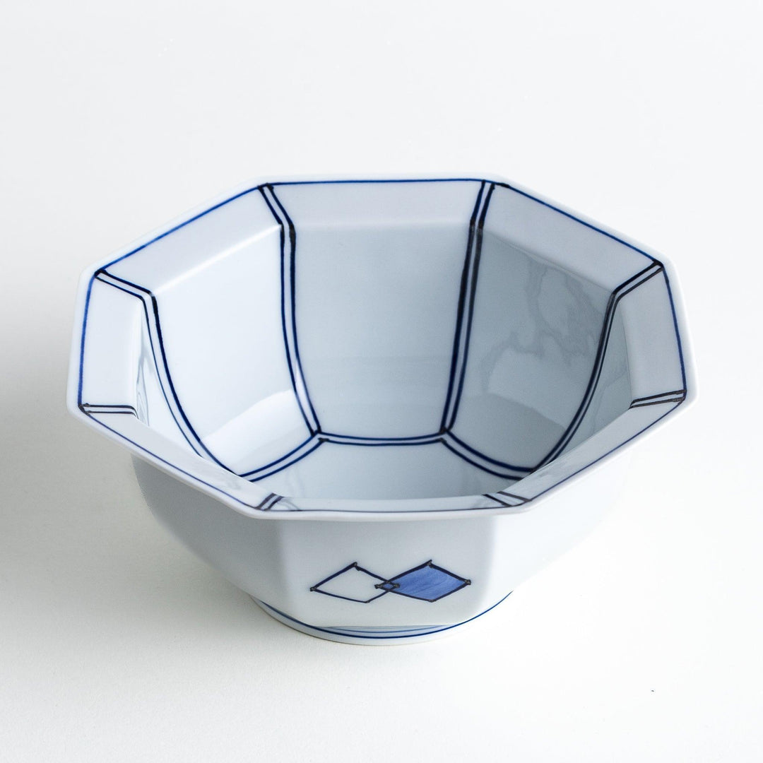An octagonal porcelain cereal bowl with a minimalist grid pattern