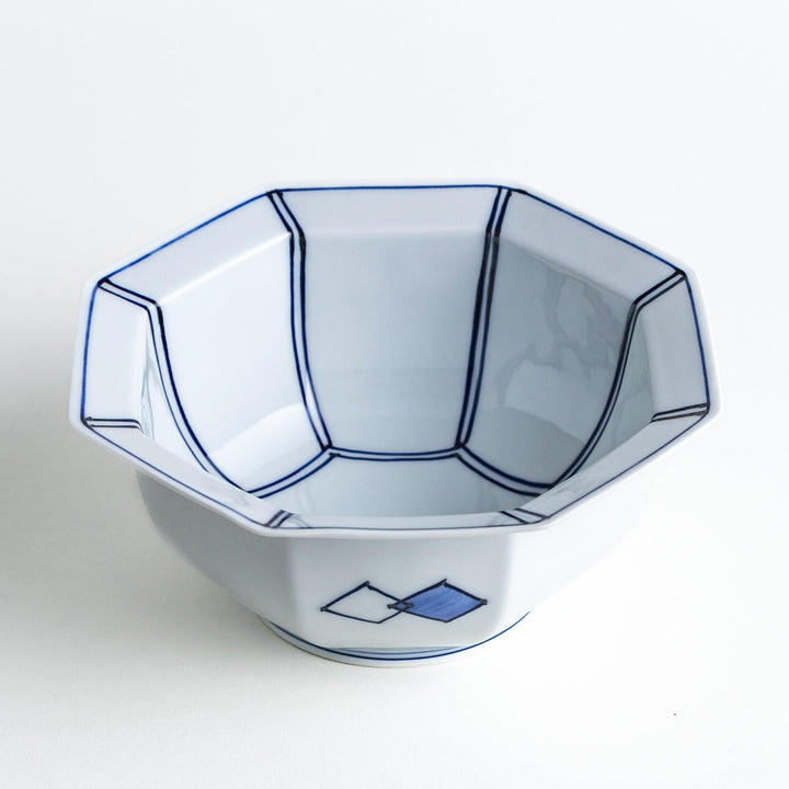 An octagonal porcelain cereal bowl with a minimalist grid pattern