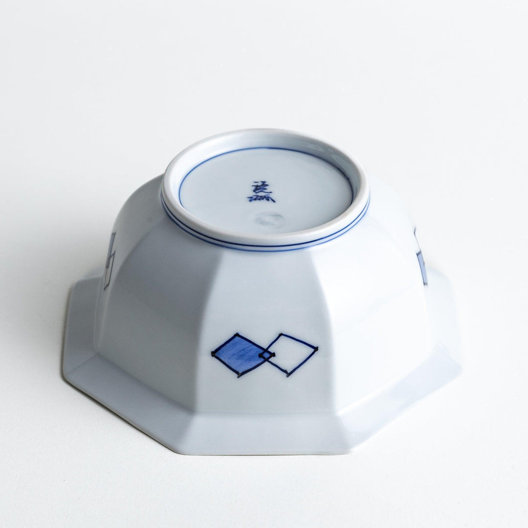 An octagonal porcelain cereal bowl with a minimalist grid pattern