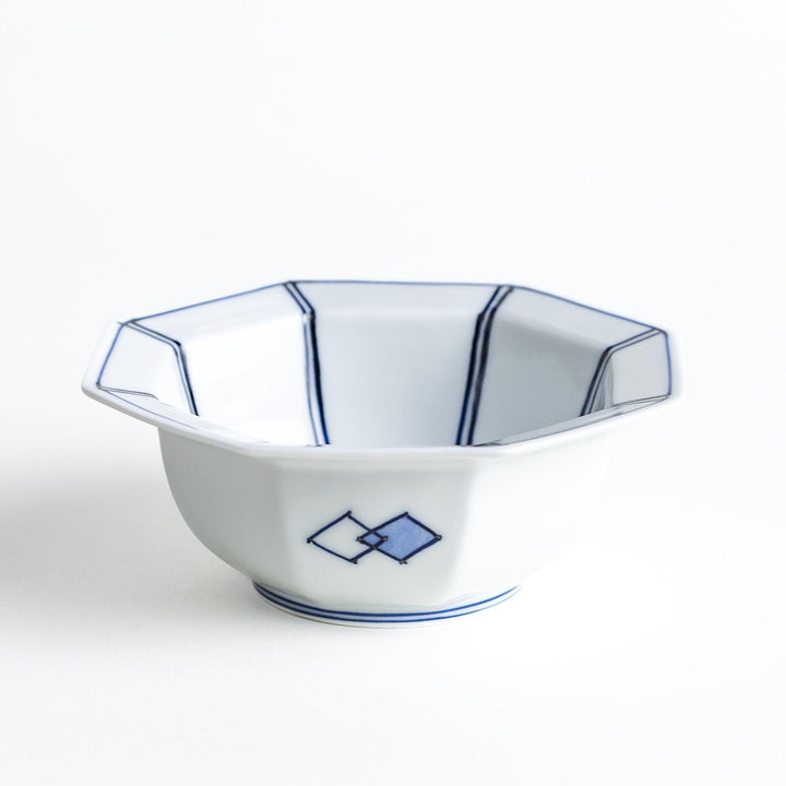 An octagonal porcelain dessert bowl with a minimalist grid pattern.