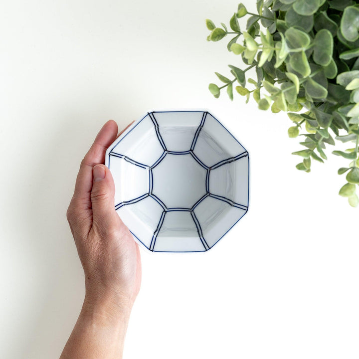 An octagonal porcelain dessert bowl with a minimalist grid pattern.