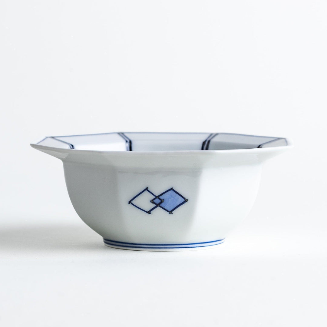 An octagonal porcelain dessert bowl with a minimalist grid pattern.