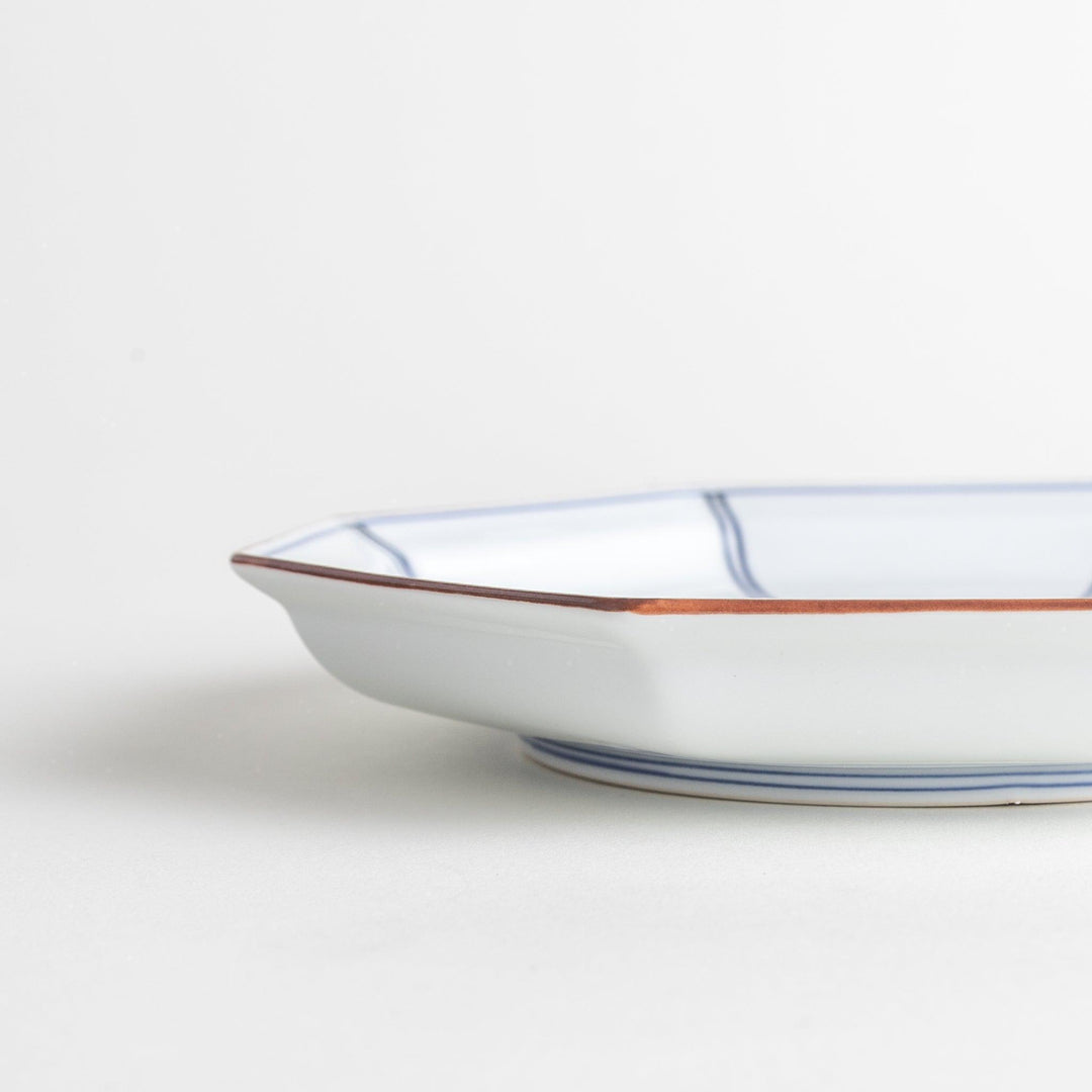 An octagonal porcelain salad plate with a minimalist grid pattern.