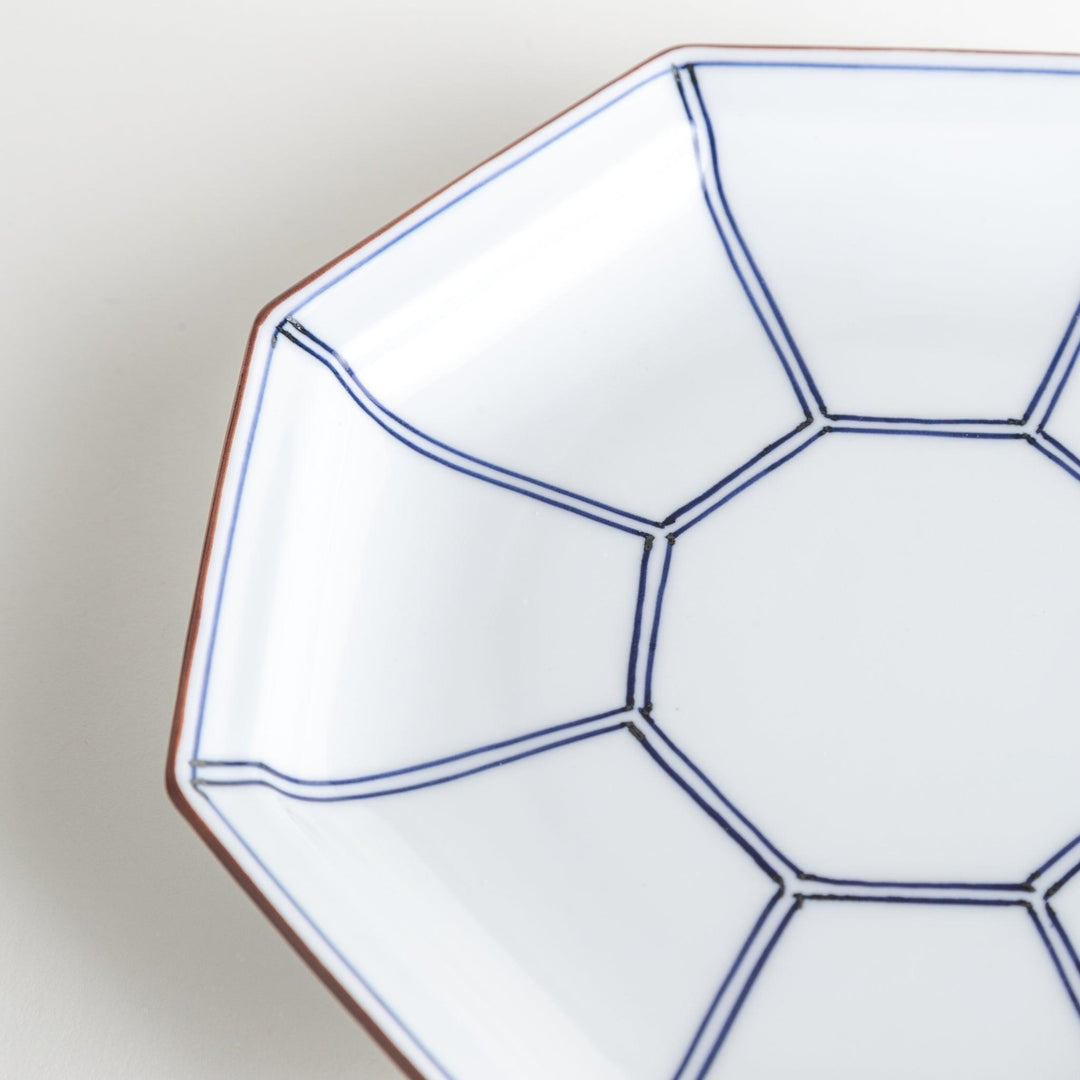 An octagonal porcelain salad plate with a minimalist grid pattern.