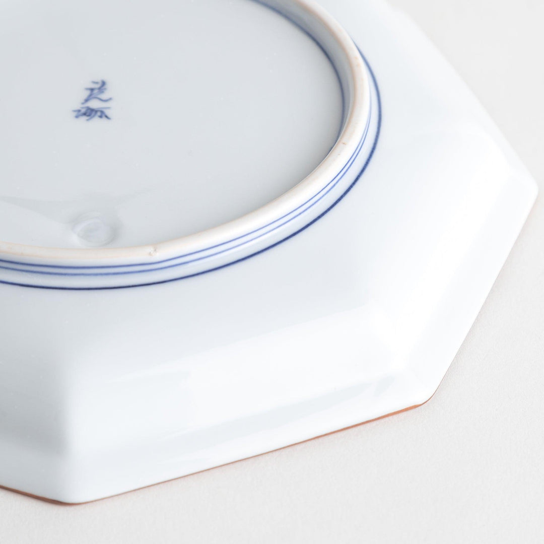 An octagonal porcelain salad plate with a minimalist grid pattern.