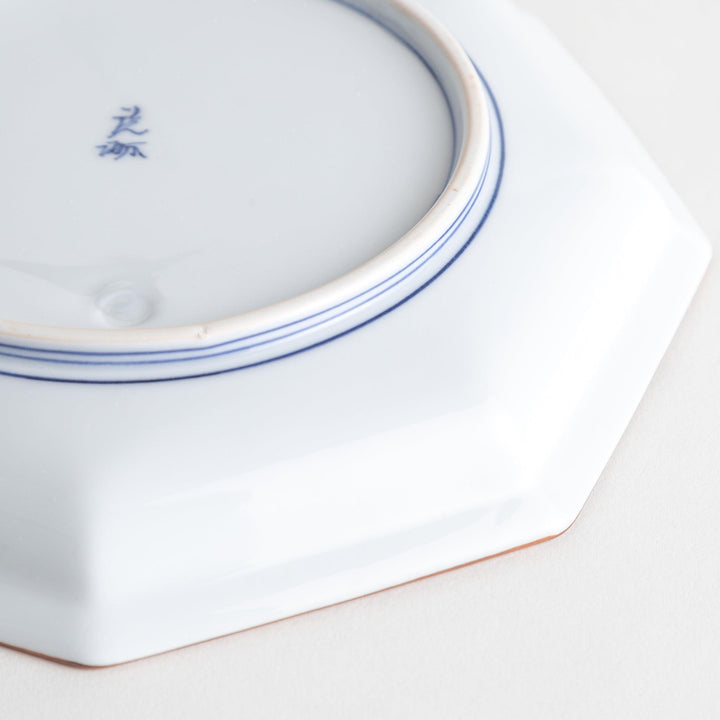 An octagonal porcelain salad plate with a minimalist grid pattern.