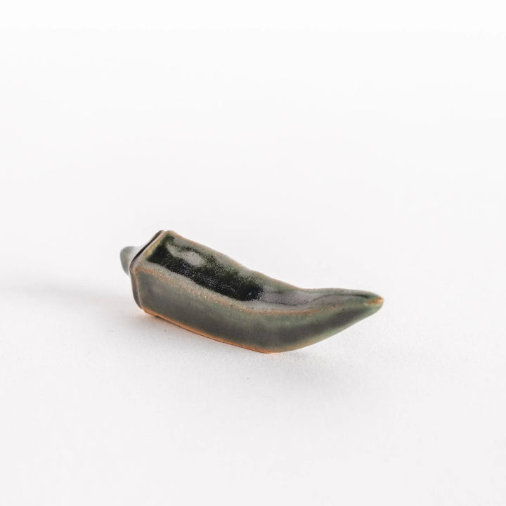 Angled view highlighting the elongated shape of the okra chopsticks rest.