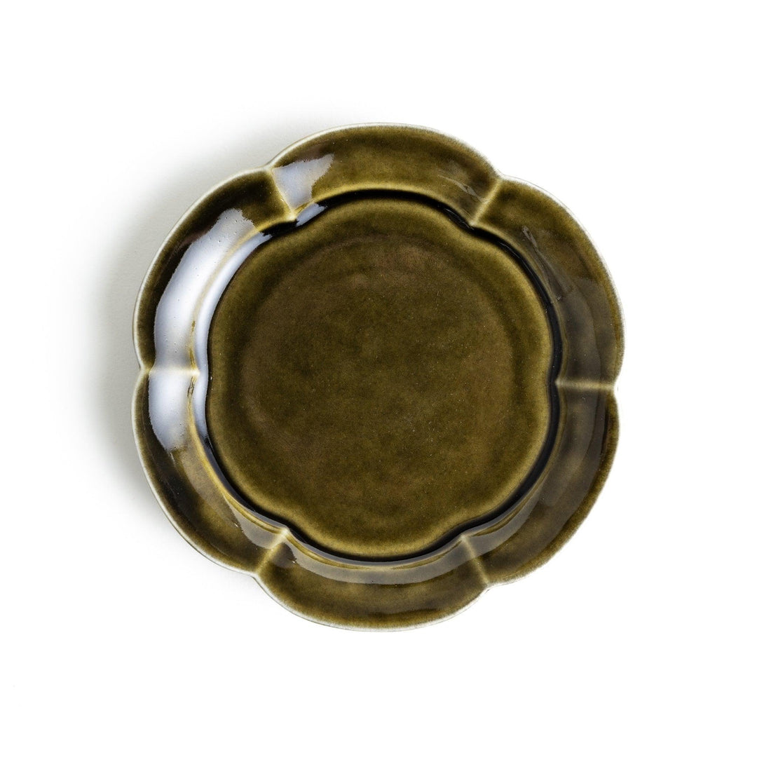 Small flower-shaped sauce dish in green, brown, and white.