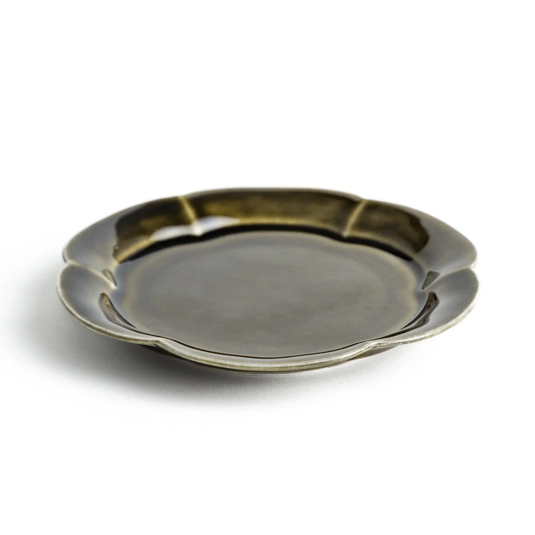 Small flower-shaped sauce dish in green, brown, and white.