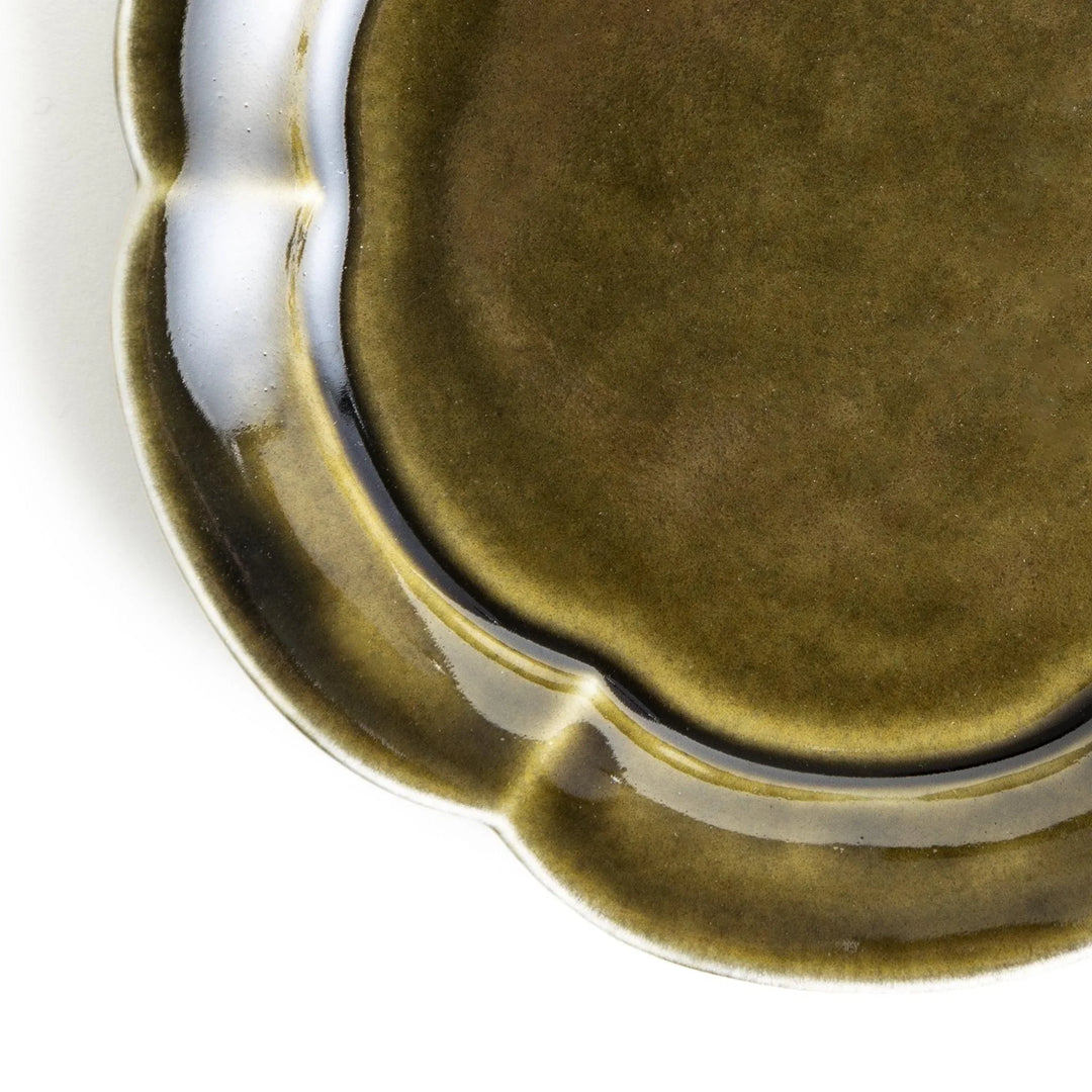 Small flower-shaped sauce dish in green, brown, and white.