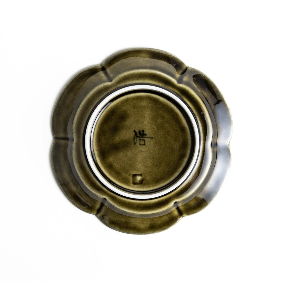 Small flower-shaped sauce dish in green, brown, and white.