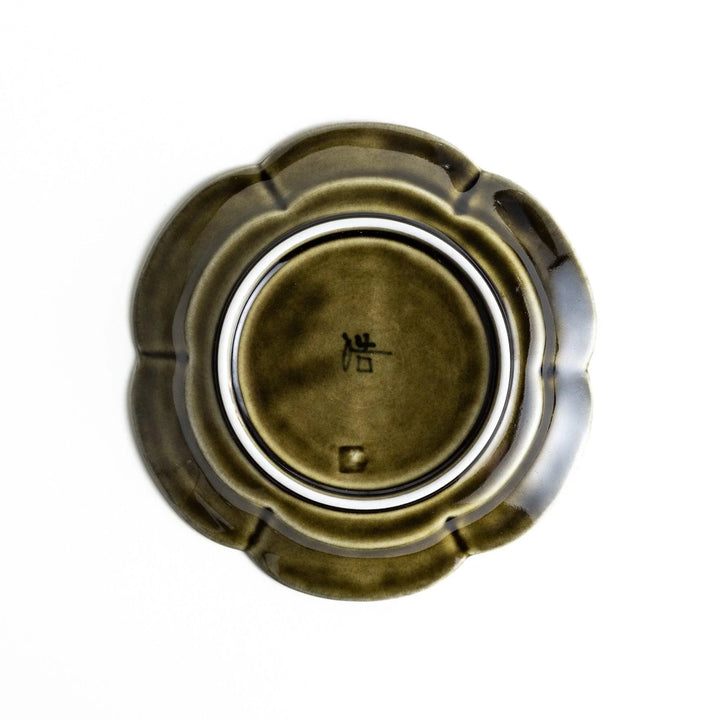 Small flower-shaped sauce dish in green, brown, and white.