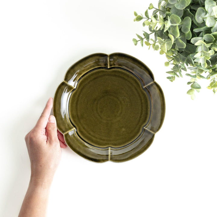 Earthy tones of olive, caramel, or off-white salad plate, with a soft, rounded shape and subtle color variations.