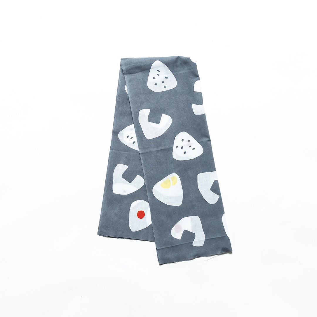 Folded gray tenugui with white rice ball patterns and accents in red, yellow, and black.