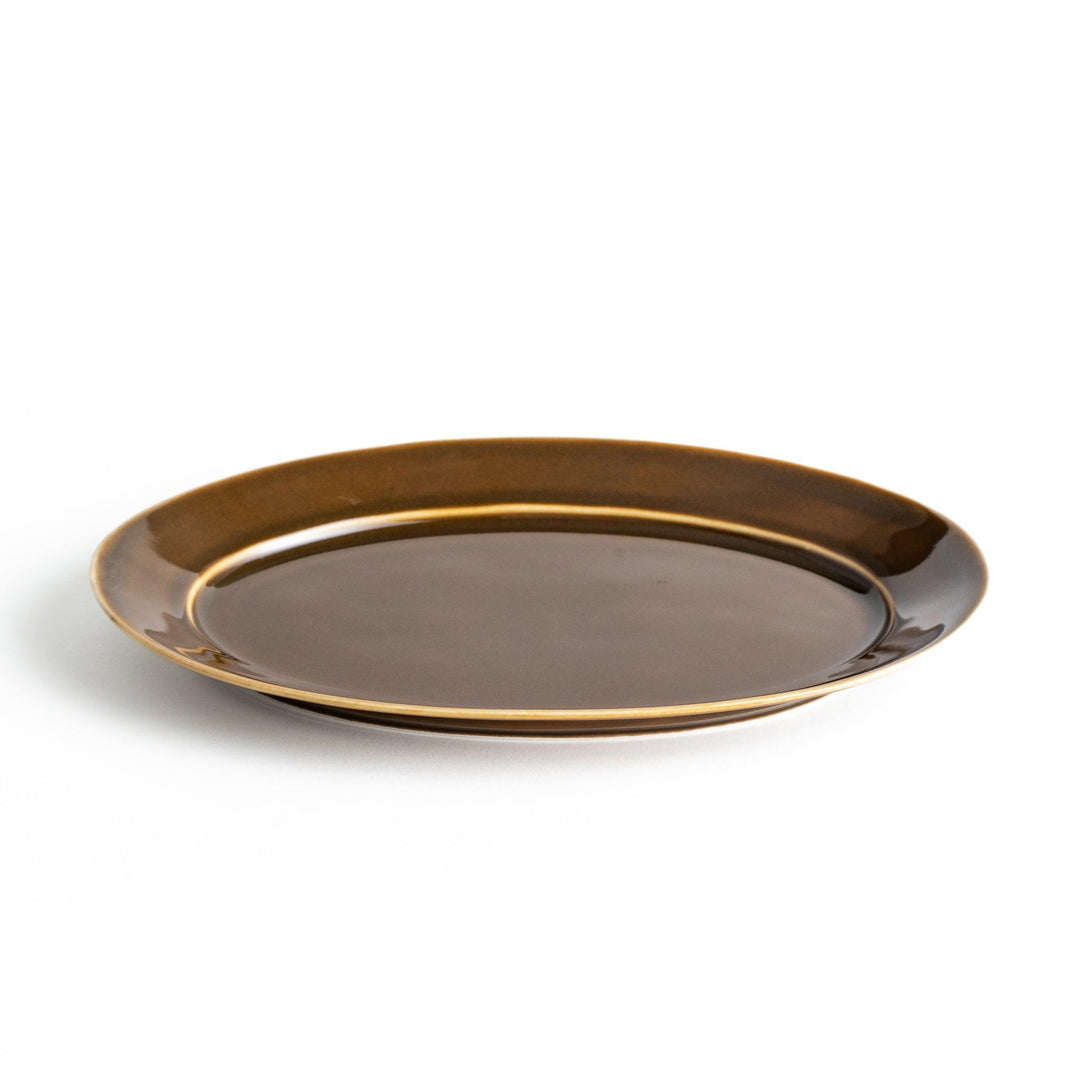 Sleek, dark brown or olive colored oval dinner plate with a glossy finish, simple and minimalist.