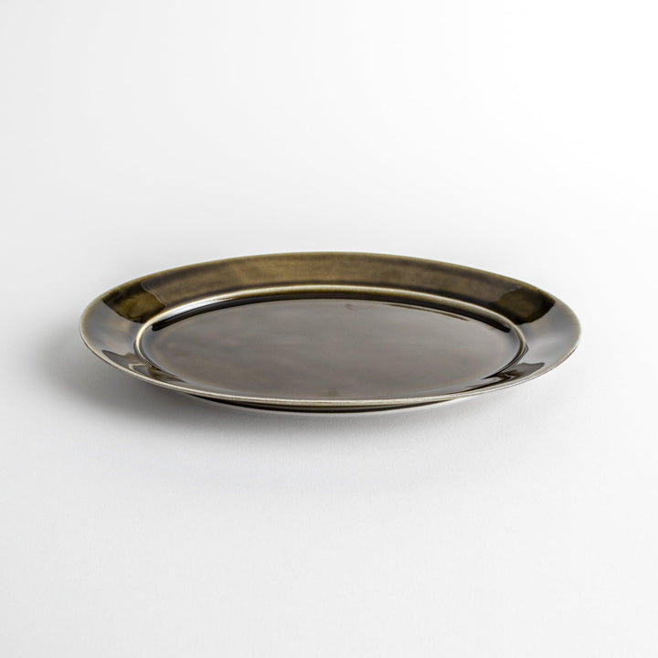 Sleek, dark brown or olive colored oval dinner plate with a glossy finish, simple and minimalist.