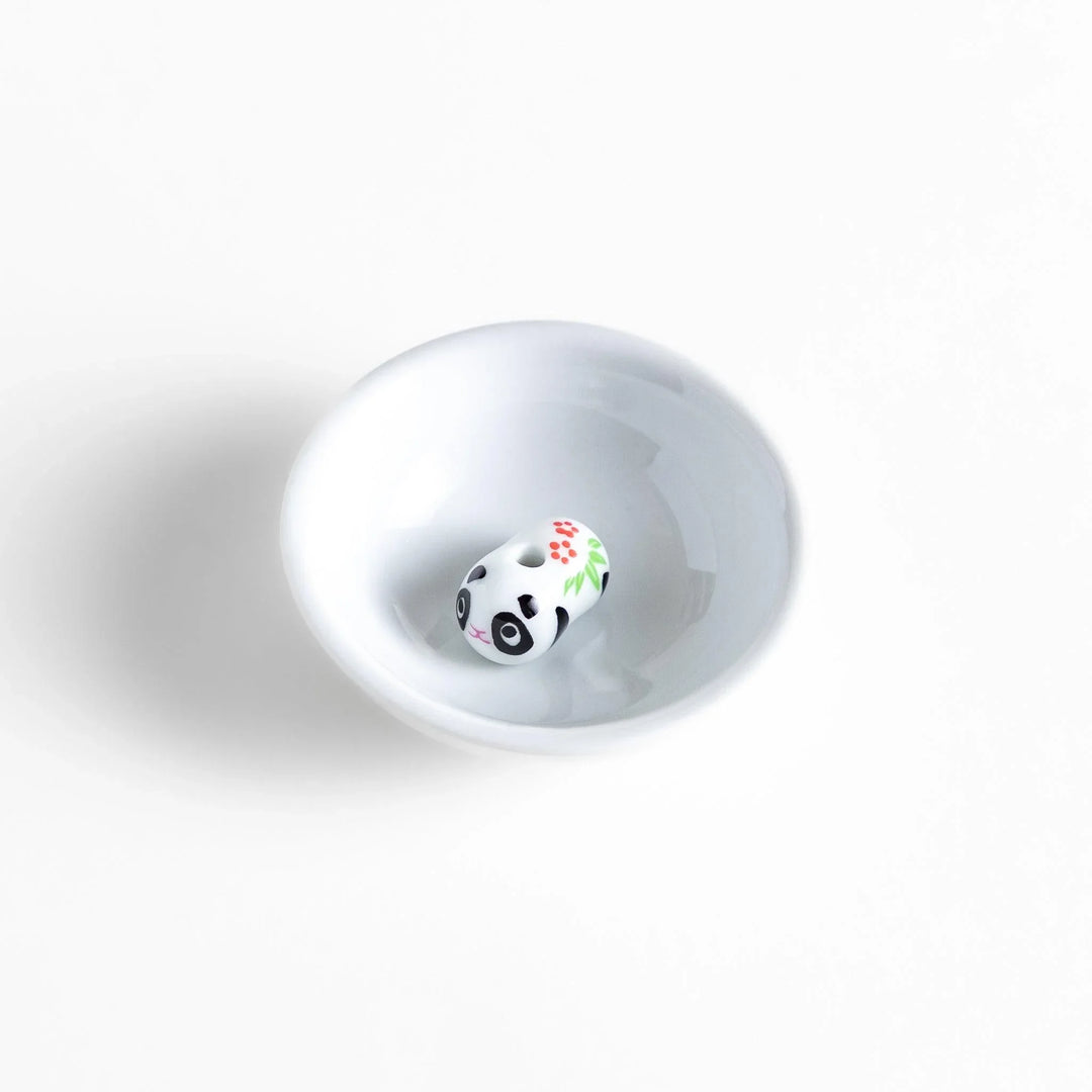 White ceramic incense holder with panda-shaped holder and floral accents adding a playful touch to home rituals.