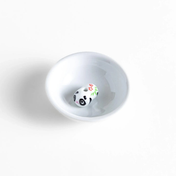White ceramic incense holder with panda-shaped holder and floral accents adding a playful touch to home rituals.