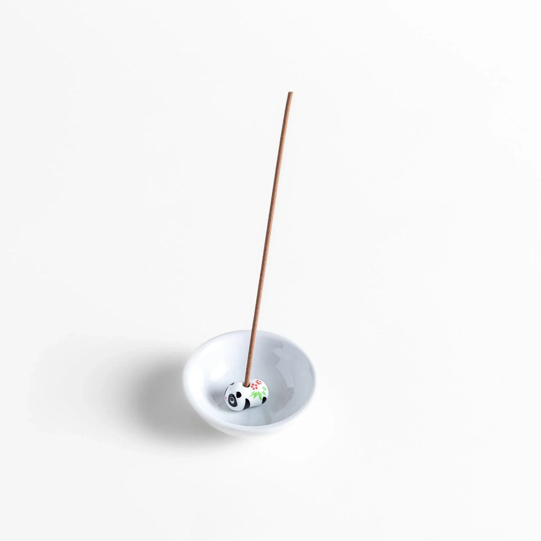 White ceramic incense holder with panda-shaped holder and floral accents adding a playful touch to home rituals.