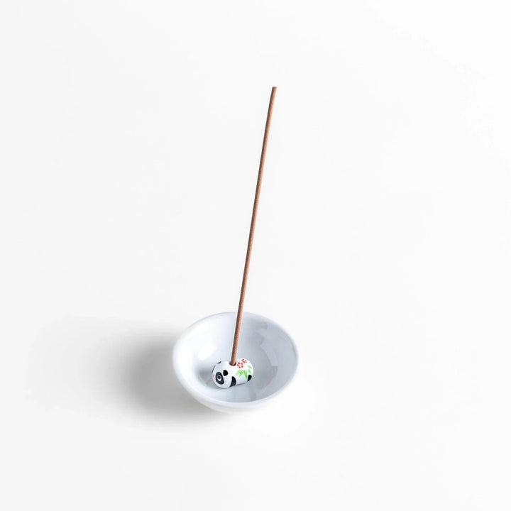 White ceramic incense holder with panda-shaped holder and floral accents adding a playful touch to home rituals.