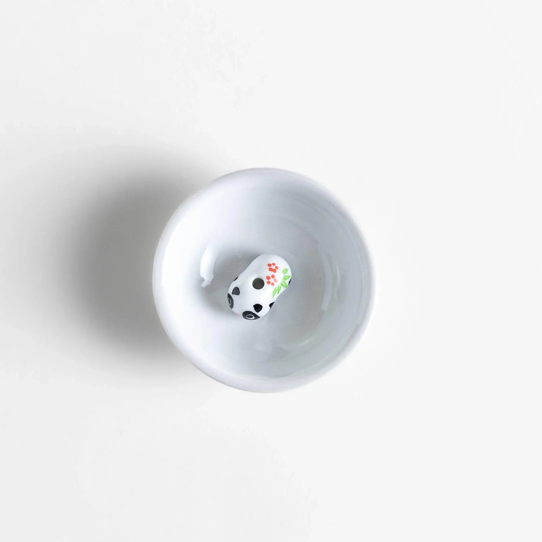 White ceramic incense holder with panda-shaped holder and floral accents adding a playful touch to home rituals.
