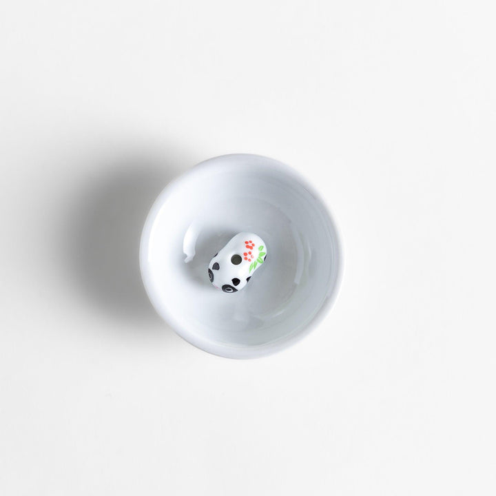 White ceramic incense holder with panda-shaped holder and floral accents adding a playful touch to home rituals.