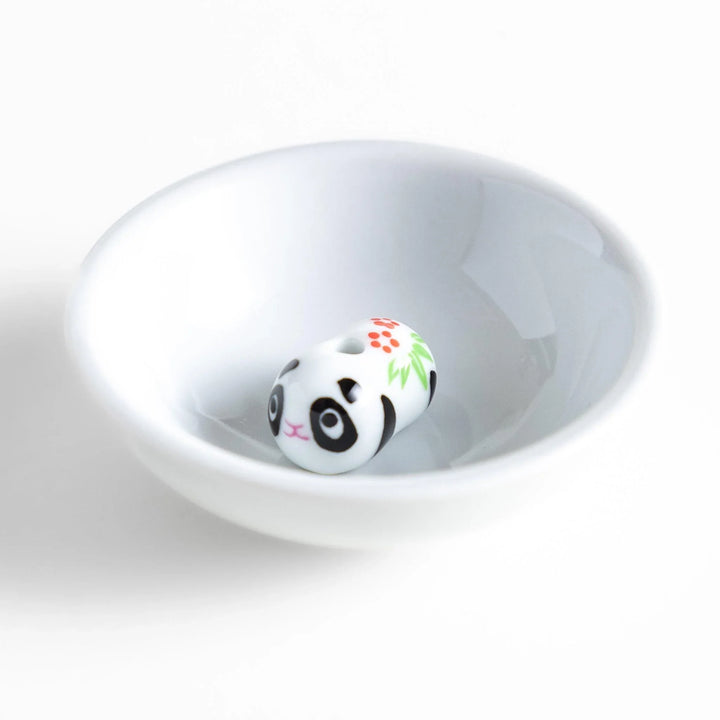 White ceramic incense holder with panda-shaped holder and floral accents adding a playful touch to home rituals.