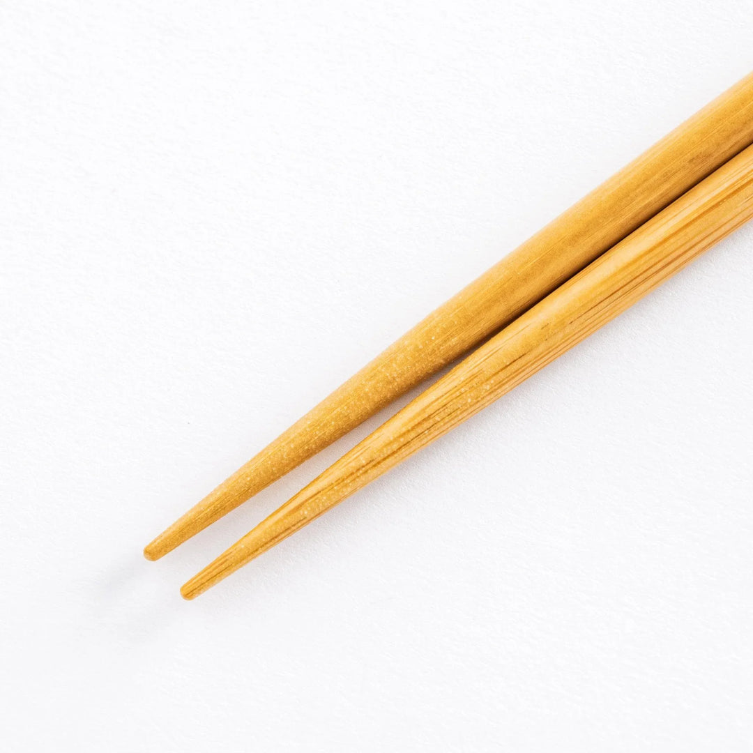 Close-up of bamboo shafts of the chopsticks, showcasing their smooth texture and sharp ends.