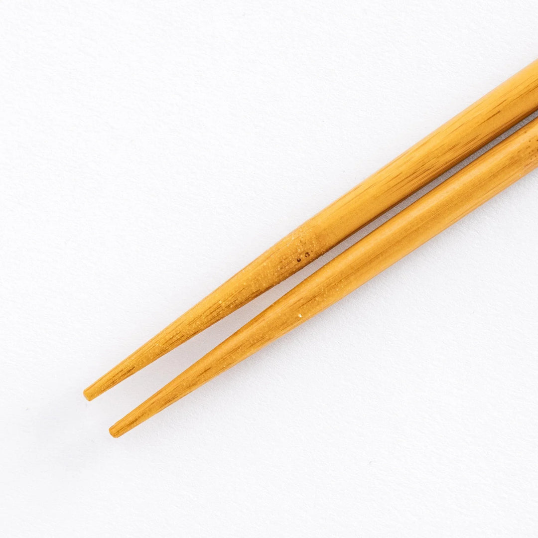 Detailed close-up showing the bamboo shafts of blue-tipped cooking chopsticks.