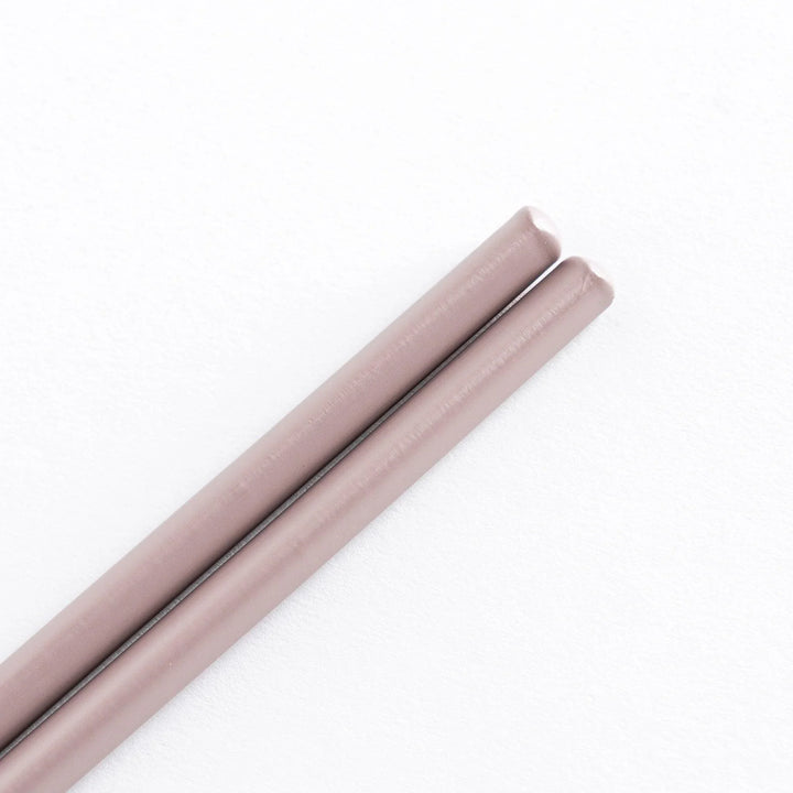 Pastel rosybrown cooking chopsticks with smooth bamboo shafts, showcasing the elegant design.