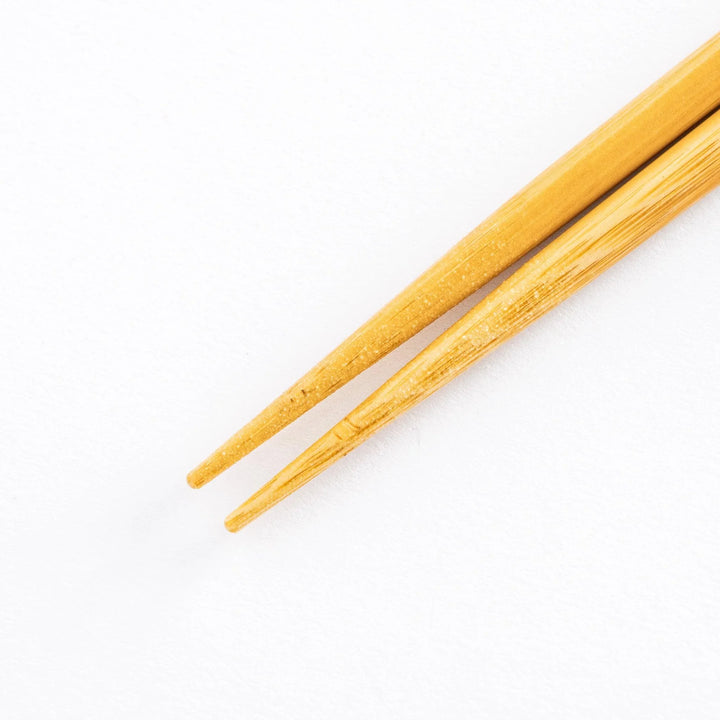 Close-up of bamboo tips of the chopsticks, showing the clean, smooth finish.