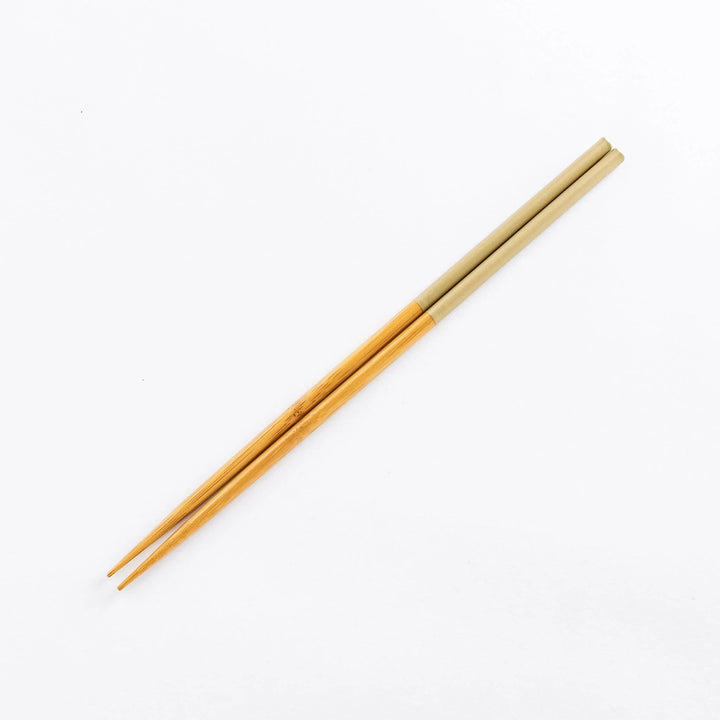 Beige-tipped cooking chopsticks with bamboo shafts, perfect for a stylish and practical kitchen accessory.