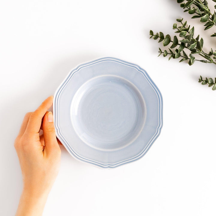 Pretty blue dessert plate with a delicate scalloped edge, ideal for showcasing your favorite treats.