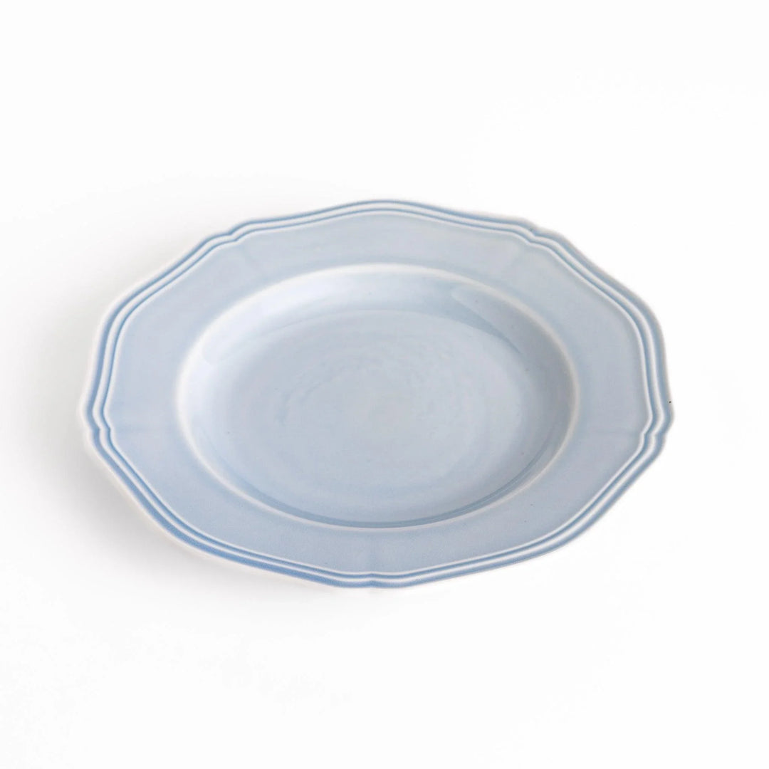 Pretty blue dessert plate with a delicate scalloped edge, ideal for showcasing your favorite treats.