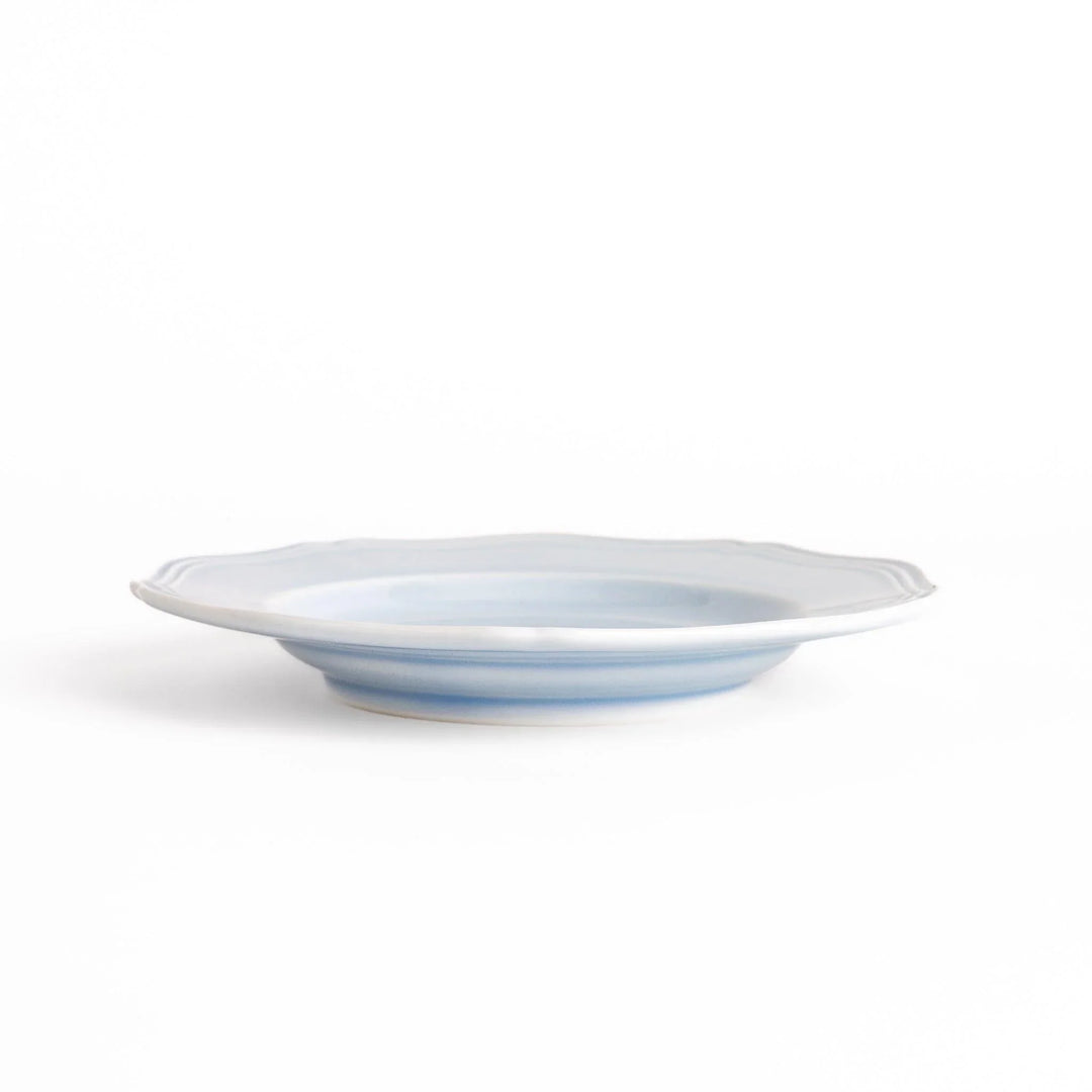 Pretty blue dessert plate with a delicate scalloped edge, ideal for showcasing your favorite treats.