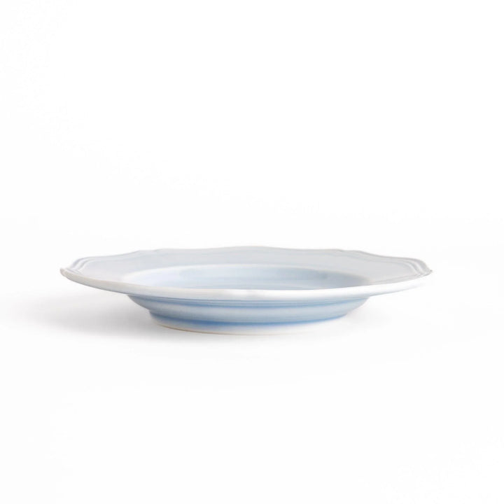 Pretty blue dessert plate with a delicate scalloped edge, ideal for showcasing your favorite treats.