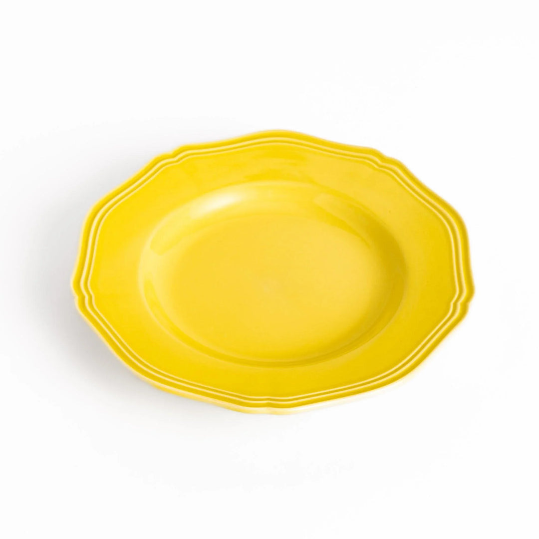 Pretty yellow dessert plate with a delicate scalloped edge, ideal for showcasing your favorite treats.
