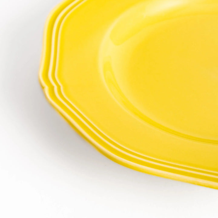 Pretty yellow dessert plate with a delicate scalloped edge, ideal for showcasing your favorite treats.