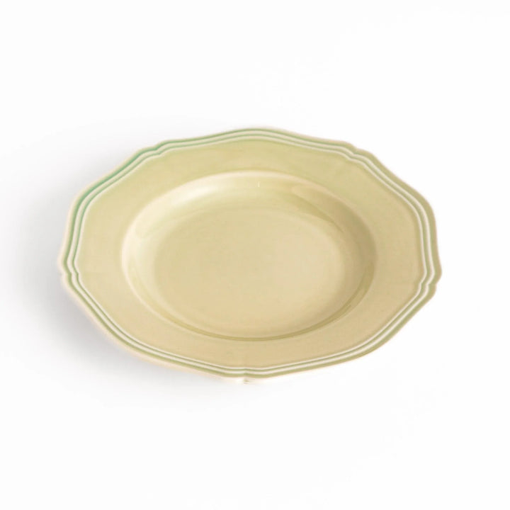 Pretty green dessert plate with a delicate scalloped edge, ideal for showcasing your favorite treats.