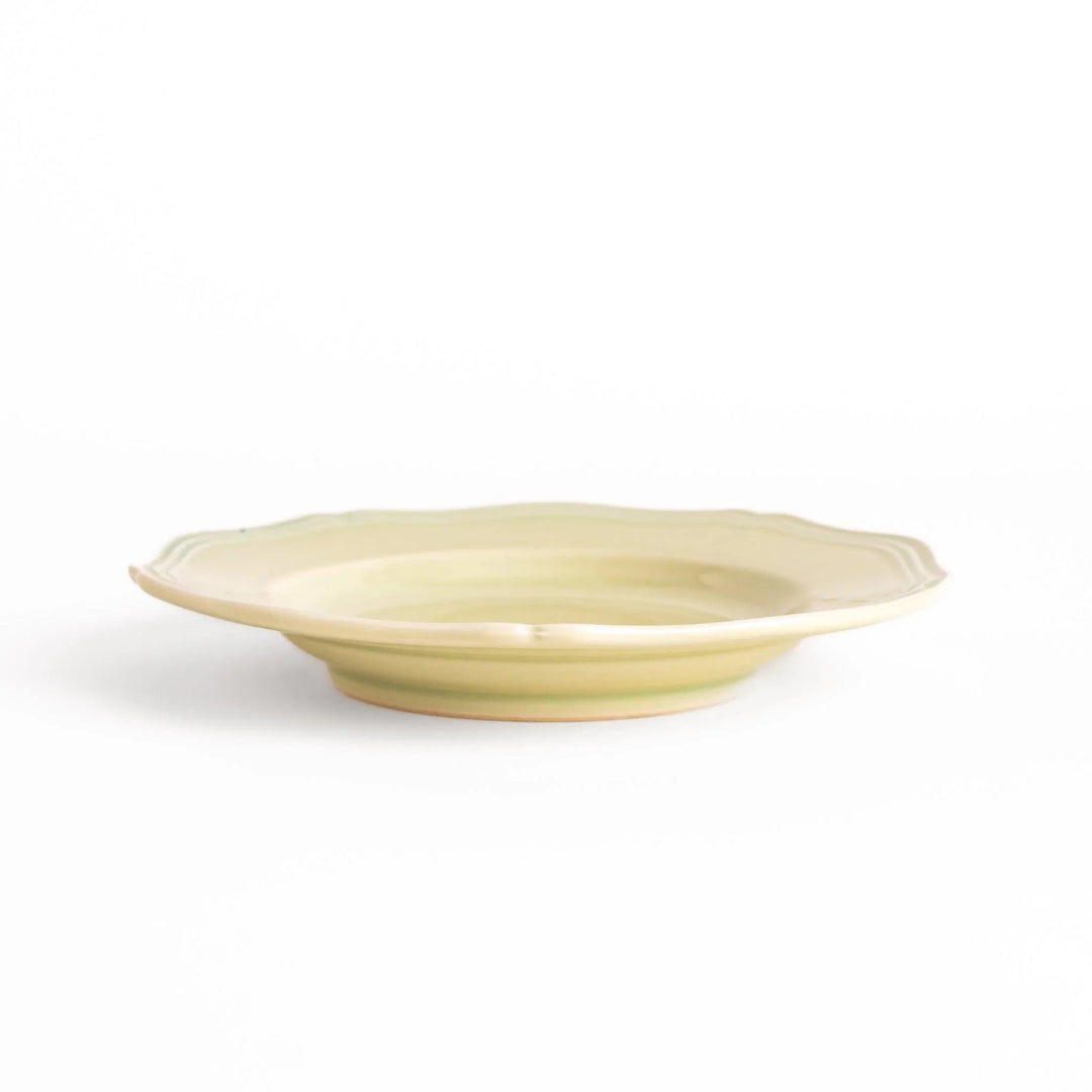 Pretty green dessert plate with a delicate scalloped edge, ideal for showcasing your favorite treats.