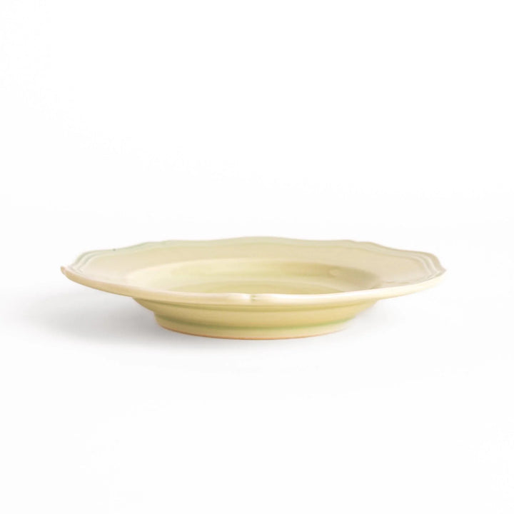 Pretty green dessert plate with a delicate scalloped edge, ideal for showcasing your favorite treats.
