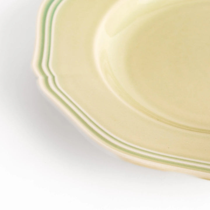 Pretty green dessert plate with a delicate scalloped edge, ideal for showcasing your favorite treats.