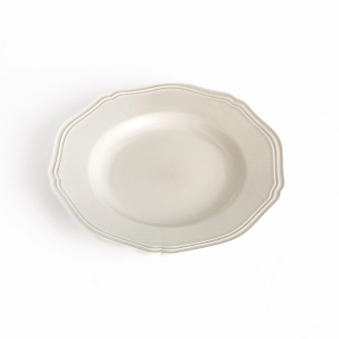 Pretty white dessert plate with a delicate scalloped edge, ideal for showcasing your favorite treats.