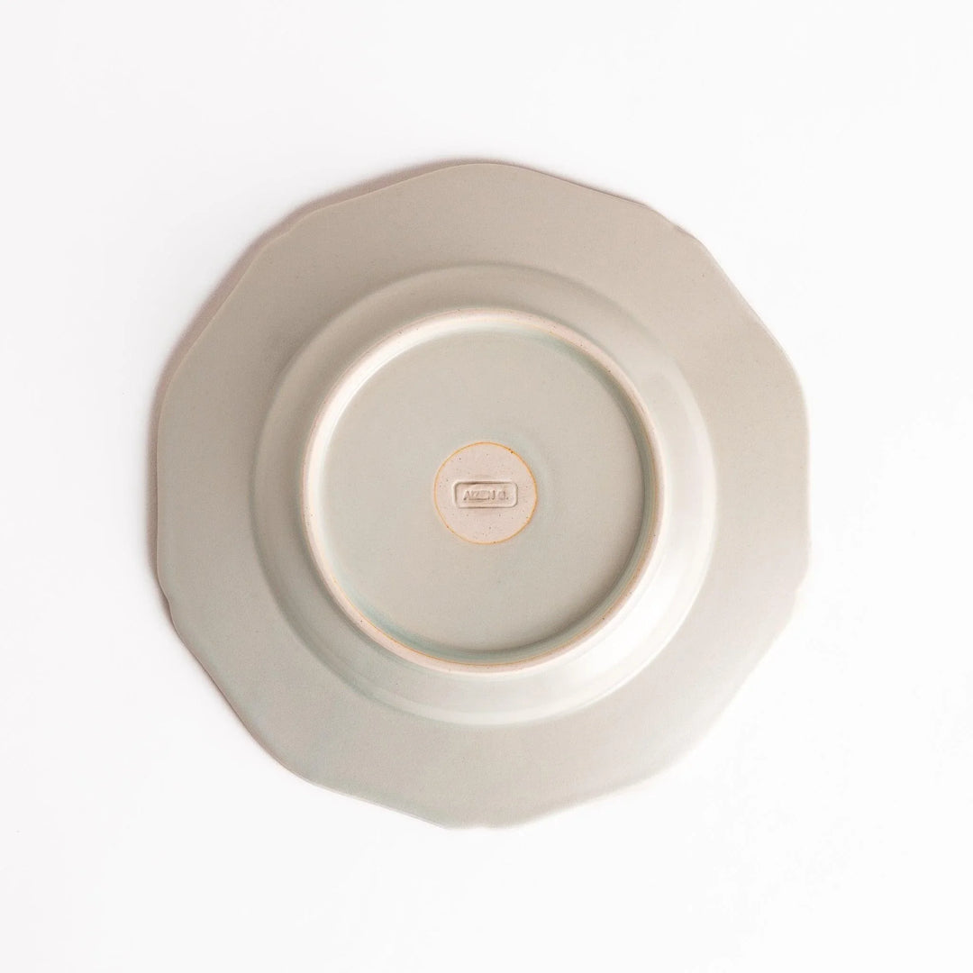 Pretty white dessert plate with a delicate scalloped edge, ideal for showcasing your favorite treats.