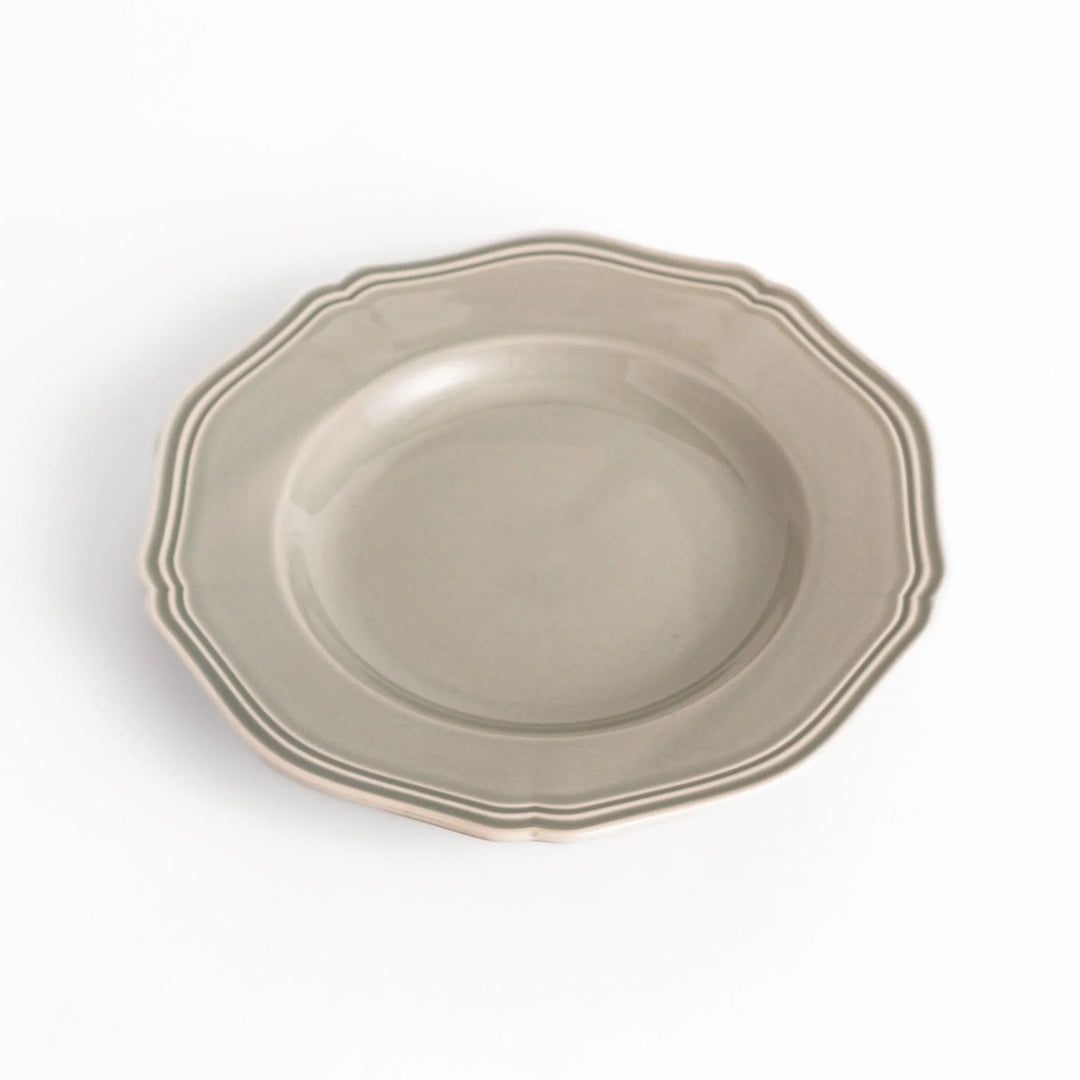 Pretty gray dessert plate with a delicate scalloped edge, ideal for showcasing your favorite treats.