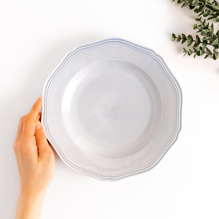 Pretty blue dinner plate with a delicate scalloped edge, ideal for showcasing your culinary creations.