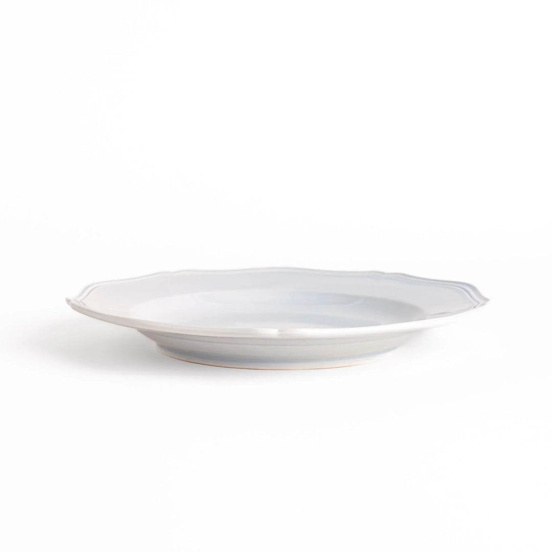 Pretty blue dinner plate with a delicate scalloped edge, ideal for showcasing your culinary creations.