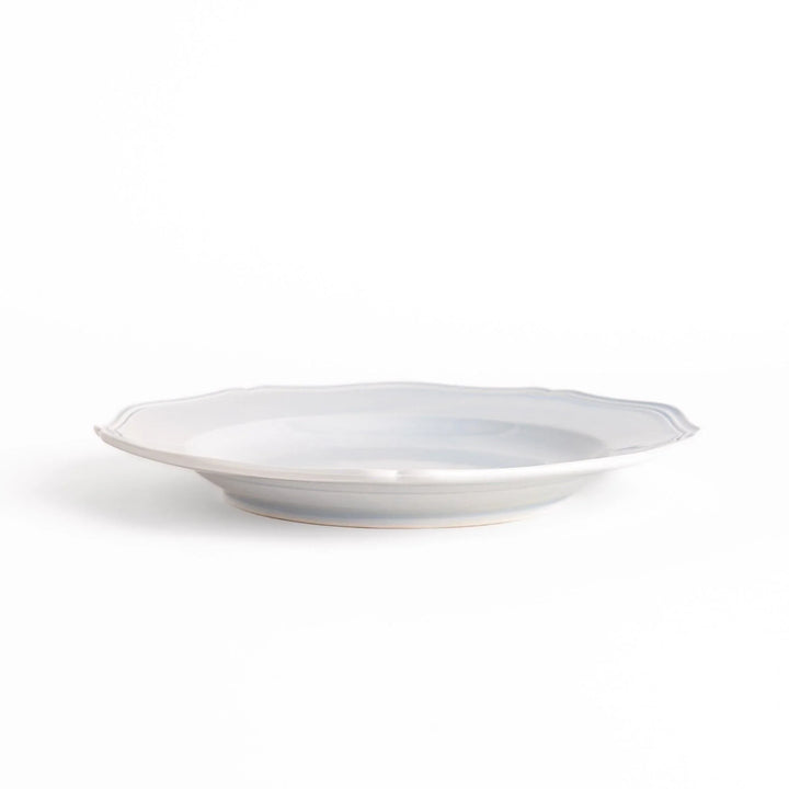 Pretty blue dinner plate with a delicate scalloped edge, ideal for showcasing your culinary creations.