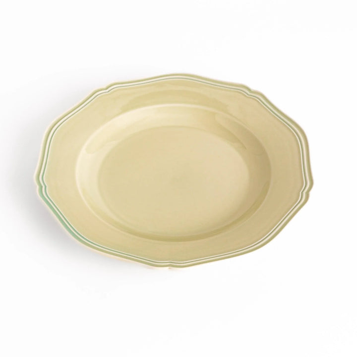 Pretty green dinner plate with a delicate scalloped edge, ideal for showcasing your culinary creations.